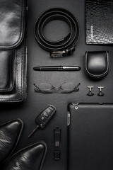 Man accessories in business style, briefcase, gadgets, shoes, clothes and other luxury businessman attributes on leather black background, fashion industry, top view - 267699218