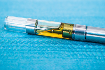 Oil Extract Vape Pen Up-close THC:CBD Concentrate With Terpenes Inside Cartridge For Consuming Marijuana Cannabinoids