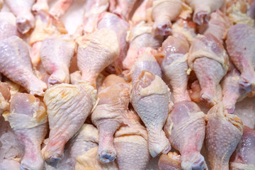 frozen chicken legs in pile on the ice