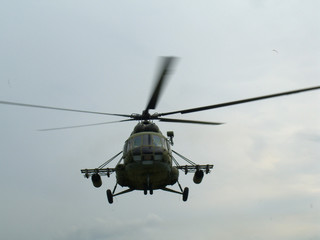 Fototapeta na wymiar Large Russian military helicopter flying against the gray sky Russian air force
