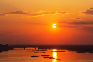 Sunset with a solar path over the river and the bridge in Nizhny Novgorod