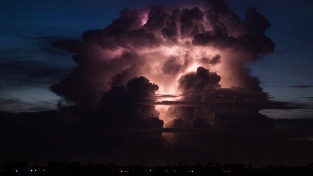 Cumulonimbus with dramatic lightning ball effects growing at blue hour, south east Asia monsoon season