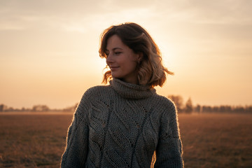 Outdoor atmospheric lifestyle photo of young beautiful  darkhaired woman  brown knit sweater made...