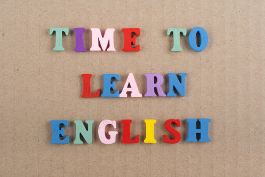 TIME TO LEARN ENGLISH word on paper background composed from colorful abc alphabet block wooden letters, copy space for ad text. Learning english concept.