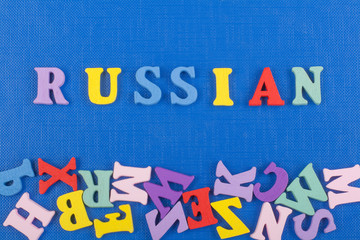 Russia word on blue background composed from colorful abc alphabet block wooden letters, copy space for ad text. Learning english concept.