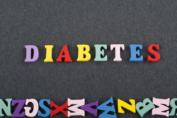 diabetes. word on black board background composed from colorful abc alphabet block wooden letters, copy space for ad text. Learning english concept.