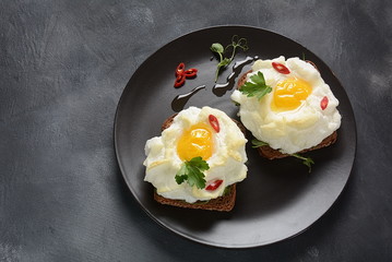 Delicate baked egg. Orsini eggs in the cloud. French breakfast.Cloud egg on toast 