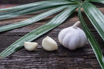 Top view of herbal vegetable ingredients, fresh garlic, on old wooden table, cooking preparation concept