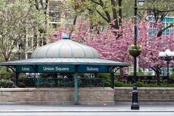 New York City subway station entrance in Union Square Park with colorful spring flowers