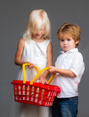 Couple kids hold plastic shopping basket toy. Mall shopping. Buy with discount. Buy products. Play shop game. Cute buyer customer client hold shopping cart. Girl and boy children shopping. Kids store
