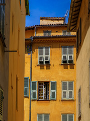 Fototapeta na wymiar Old traditional houses in the narrow streets in the Old Town Vielle Ville in Nice in the South of France