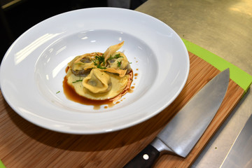 main dish setting up on a chop board with big knife