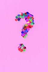 Holographic glitter question mark from sequins.Copy space.