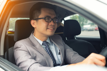 happy young business man driving in the car