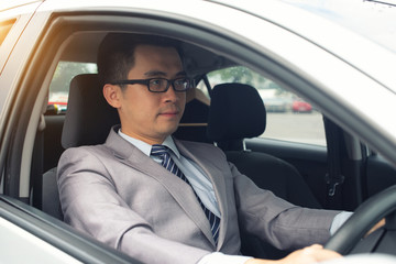 happy young business man driving in the car