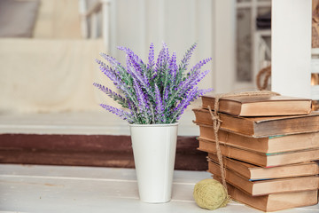 Shabby chic style. decoration with vintage books and lavender.Shabby chic interior decor for farmhouse. Lavender in pitcher, books.Provence home decoration.