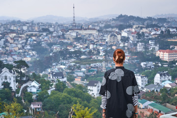 Woman overlooking the city view, Dalat, Vietnam
