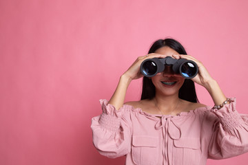 Young Asian woman with binoculars.