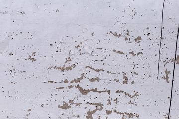 plastered brick wall with whitewash,with sloppy brick and crumbling whitewash,taken on a Sunny spring day