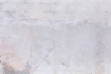 plastered brick wall with whitewash,with sloppy brick and crumbling whitewash,taken on a Sunny spring day