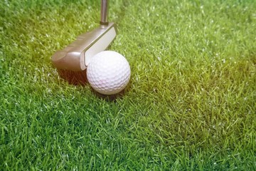 Golf ball on green grass background