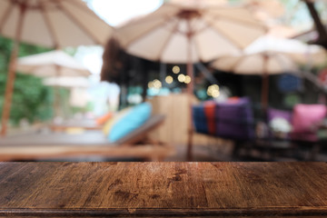 Obraz na płótnie Canvas Empty dark wooden table in front of abstract blurred bokeh background of restaurant . can be used for display or montage your products.Mock up for space.