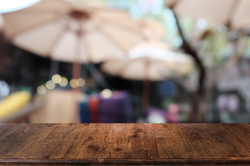 Empty dark wooden table in front of abstract blurred bokeh background of restaurant . can be used for display or montage your products.Mock up for space.