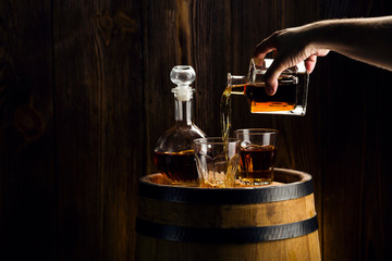 man hand pouring alcoholic beverage into a glass