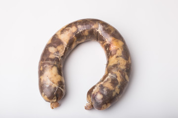 Food, meat and delicious concept - sausage made with horse meat on the table