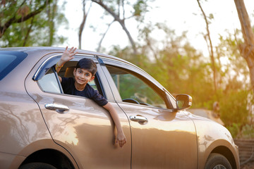 Obraz na płótnie Canvas Cute Indian child in car