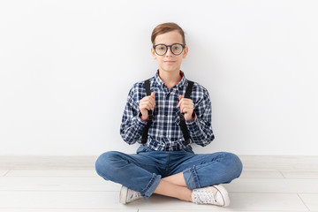 teenager, children and fashion concept - Funny boy with glasses and shirt suspenders