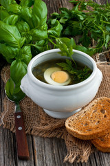 Soup with sorrel and eggs in bowl on the table