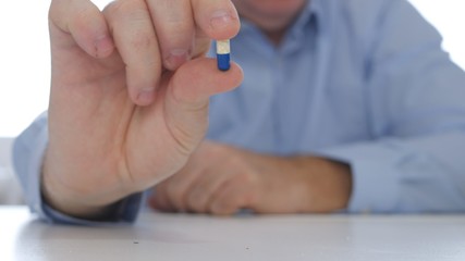 Confident Person Recommend a New Treatment Showing in Hand One Medical Capsule