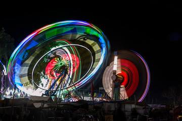 colorful lights of  moving swings in nights during pushkar camel fair, pushkar, rajasthan, india