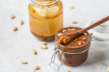 Homemade salted caramel with nuts in glass jar, copy space. Ingredient for cake snickers.