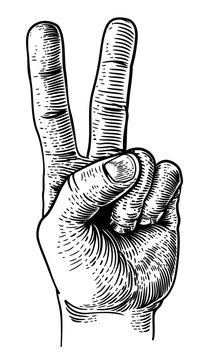 A hand in a peace or v for victory sign. Iin a vintage antique engraving woodblock or woodcut style.