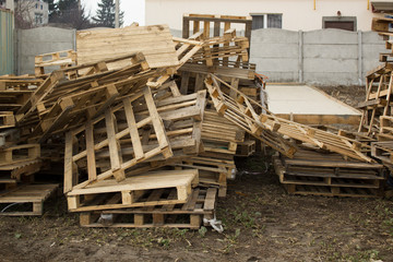 Huge stack of different type of pallet at a recycling business outdoor area