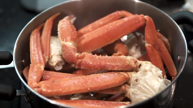 slow motion closeup steaming opilio or snow crab.