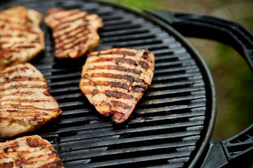 Grilled turkey meat. Steak turkey grill on on huge gas grill . Picnic. Summer. Top view. Flat lay. Copy space.