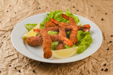 fried shrimps with lemon on plate