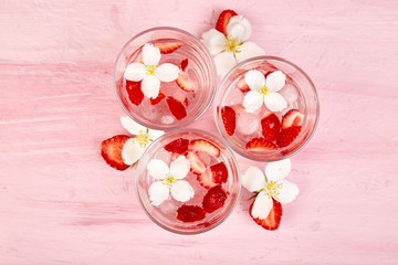 Strawberry detox water with jasmine flower. Summer iced drink