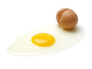 Wire whisk and brown eggs on white background