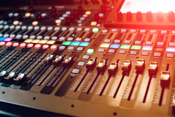 Remote sound engineer. Many buttons of black audio mixer board console. Music equipment. Close-up