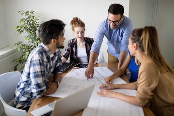 Image of business partners discussing documents and ideas