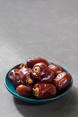 Dried dates on gray background. Vertical orientation, copy space