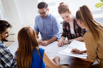 Image of business partners discussing documents and ideas