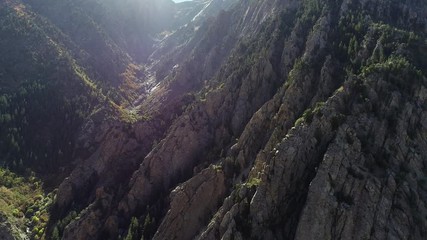 Aerial dolly shot over large rugged granite cliffs in Cottonwood Canyon