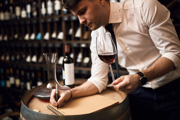 good looking sommelier concentrated on his work at the restaurant. close up photo