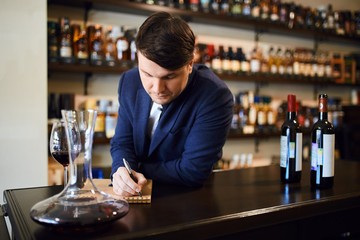 young fashionable man planning the wine menu. close up photo. copy space. the practise of wine tasting
