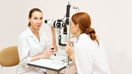 Fototapeta na wymiar Eye ophthalmologist exam. Eyesight recovery. Astigmatism check concept. Ophthalmology diagmostic device. Beauty girl portrait in clinic